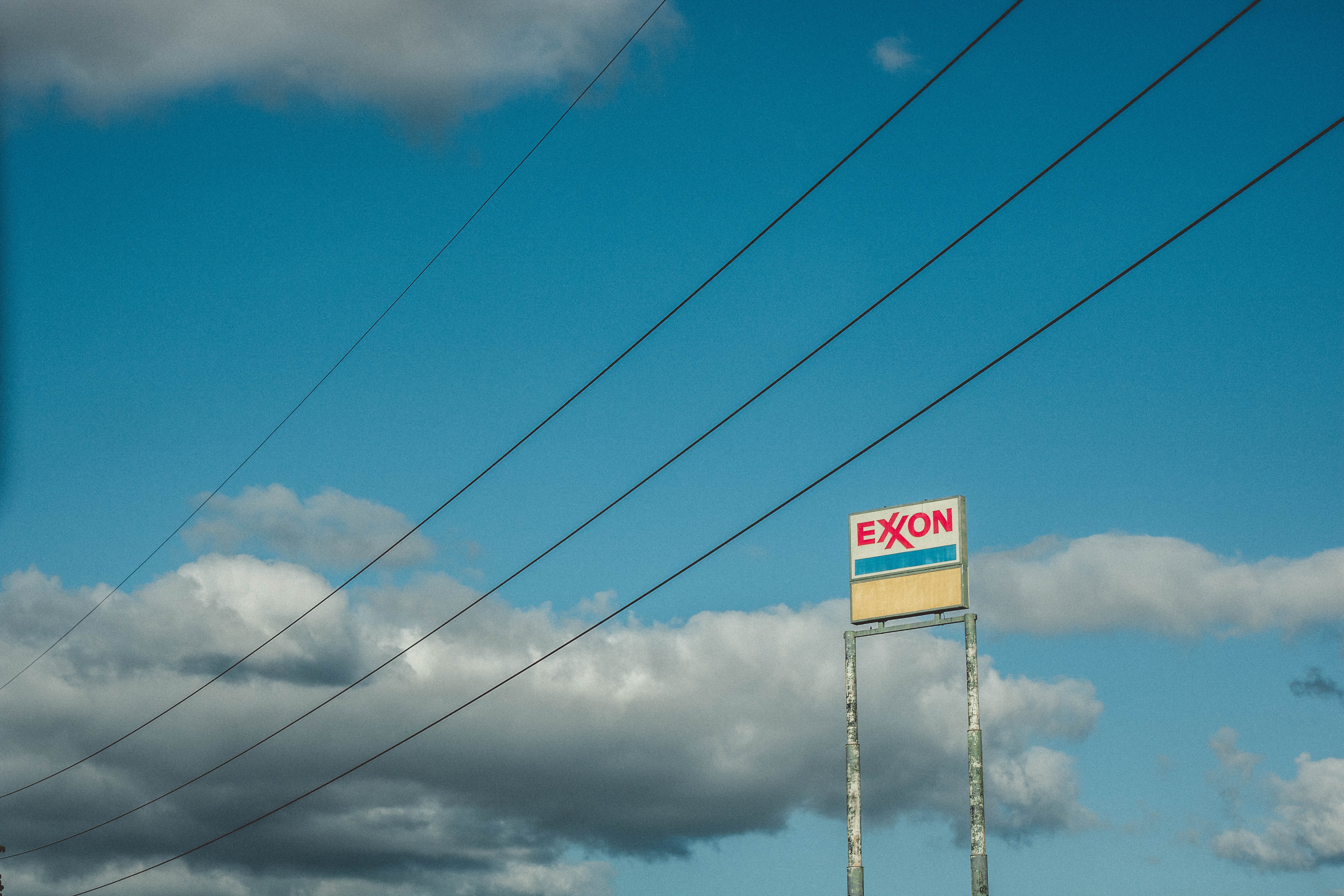 A tall Exxon sign from below. 