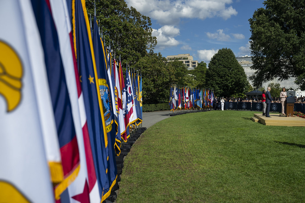 Surrounded by state flags, President Biden and Vice President Harris deliver remarks at the celebration event for the Inflation Reduction Act.