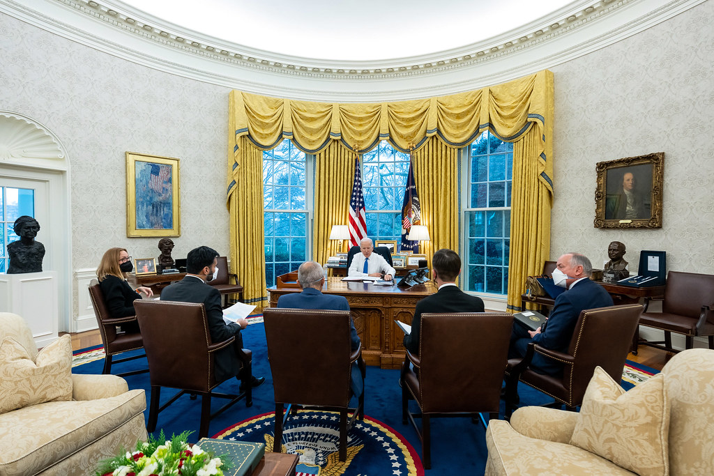 President Joe Biden meeting with staff about the Willow Project in the Oval Office.