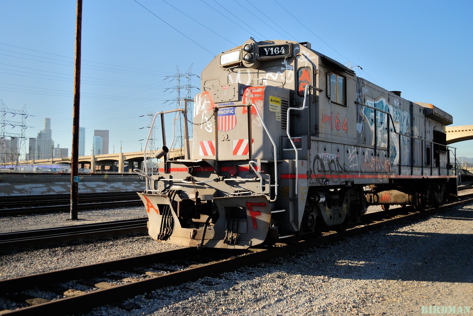 Close up of a freight train with graffiti passing on the outskirts of Los Angeles.