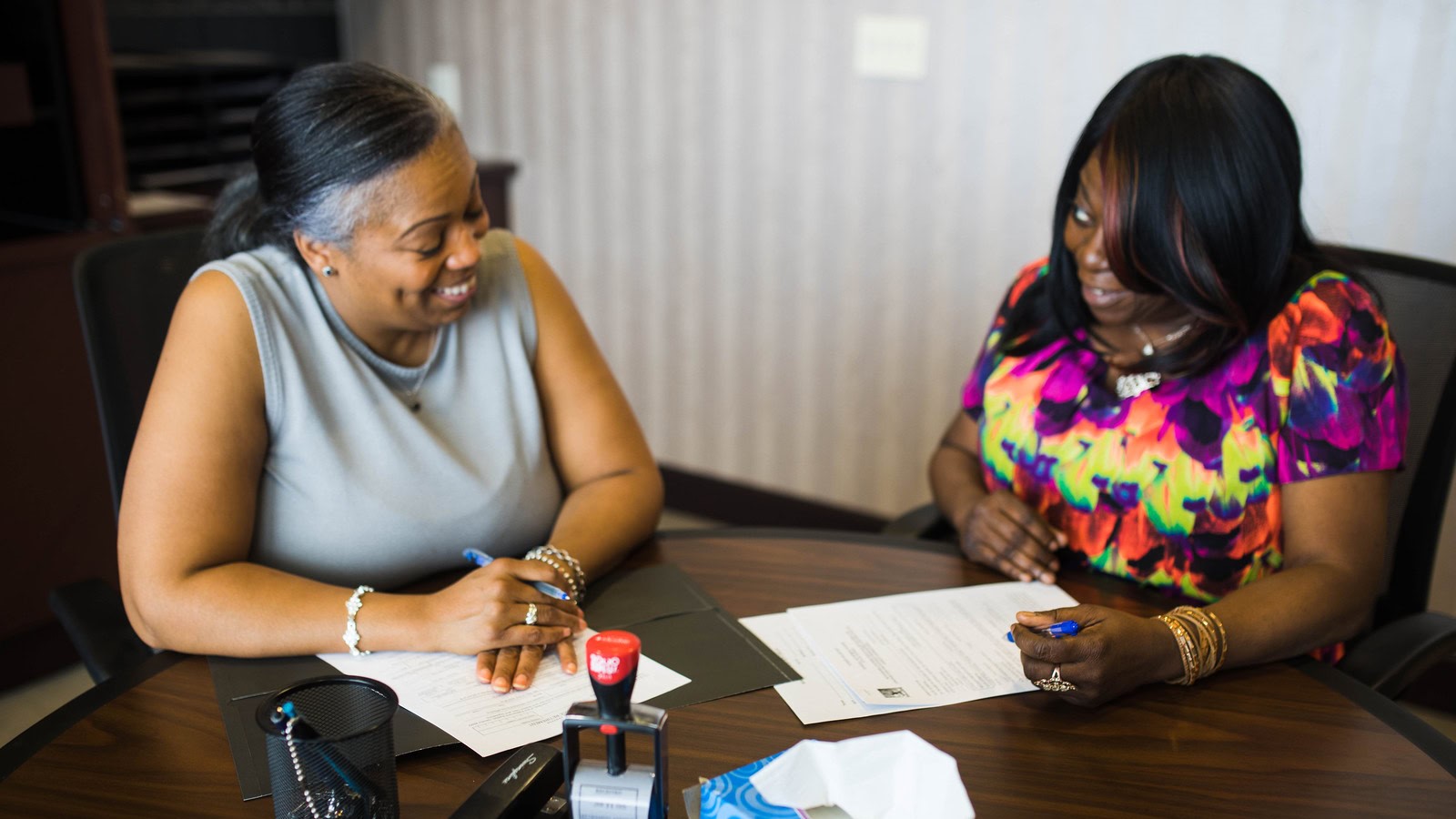 Two Michigan women discussing paperwork