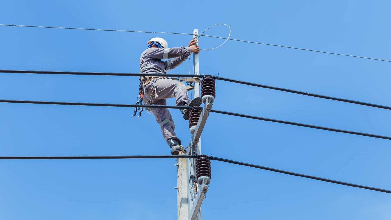 A worker performing maintenance on a power line.